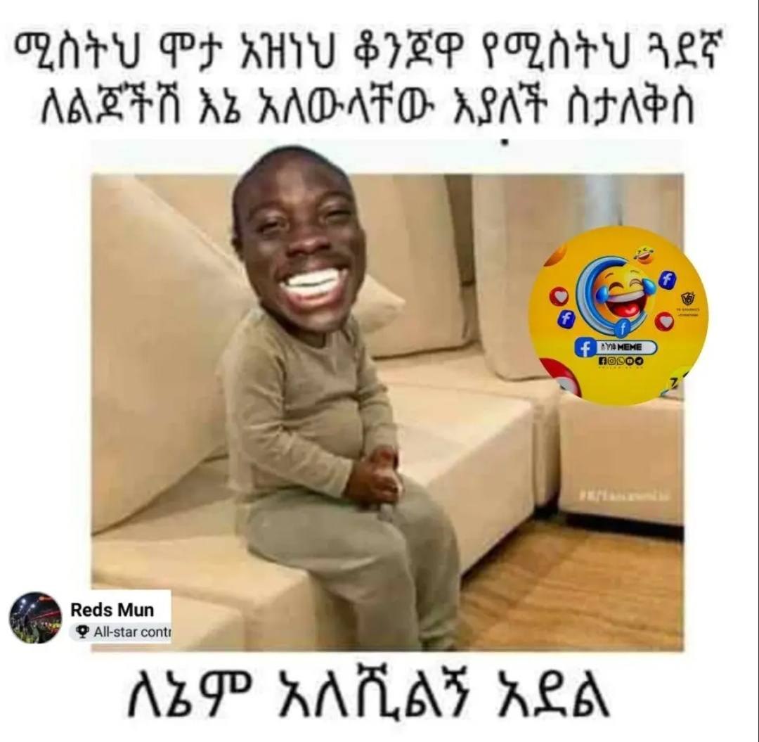 a young boy is laughing and sitting on a couch